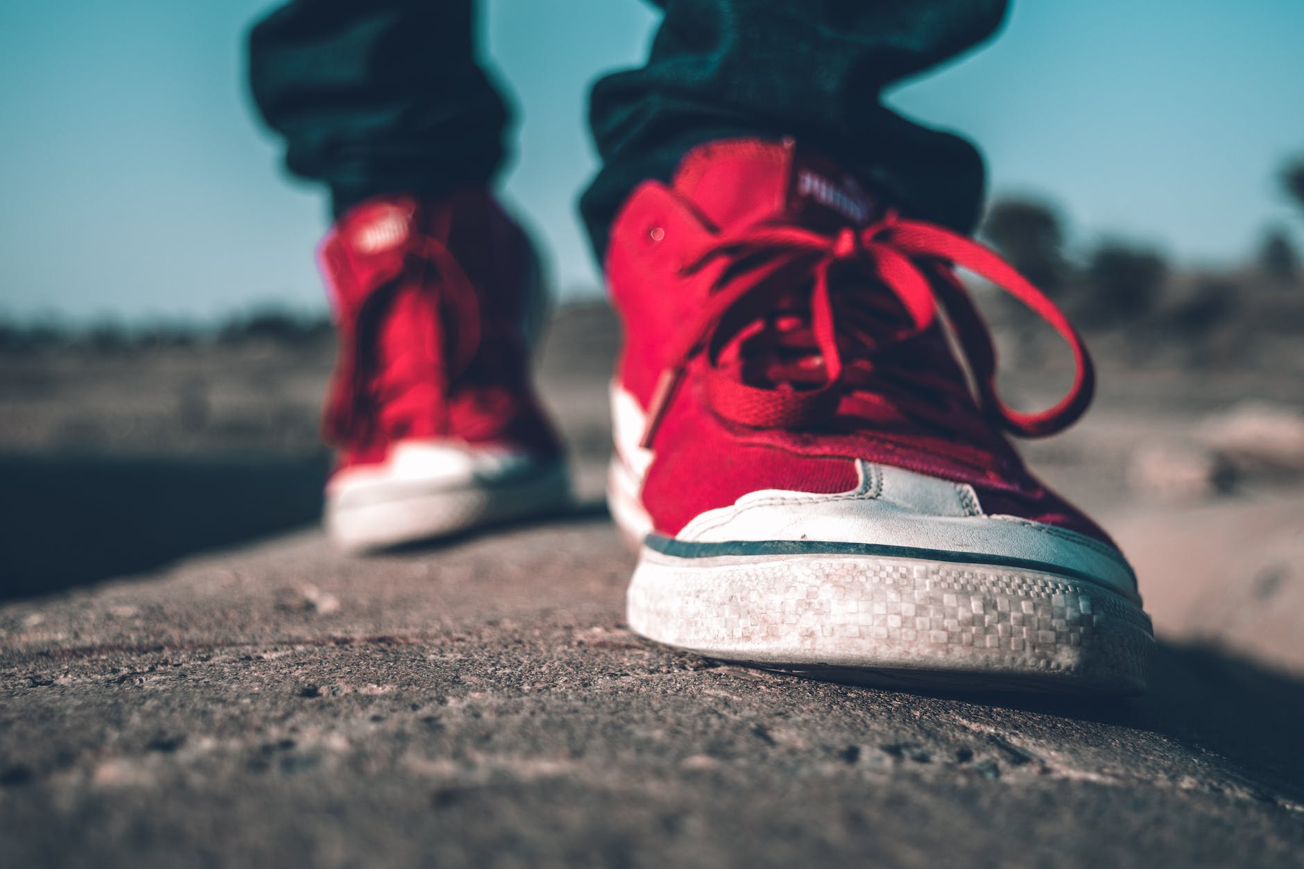 photo of person wearing red shoes