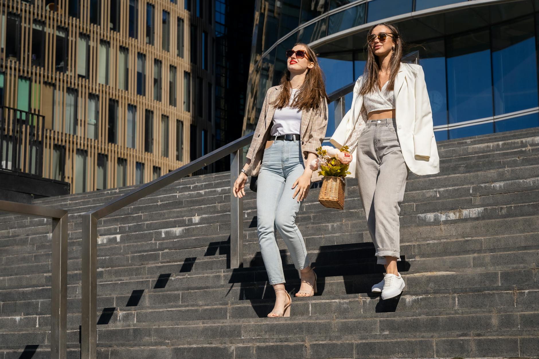 woman in white blazer and beige pants walking on stairs